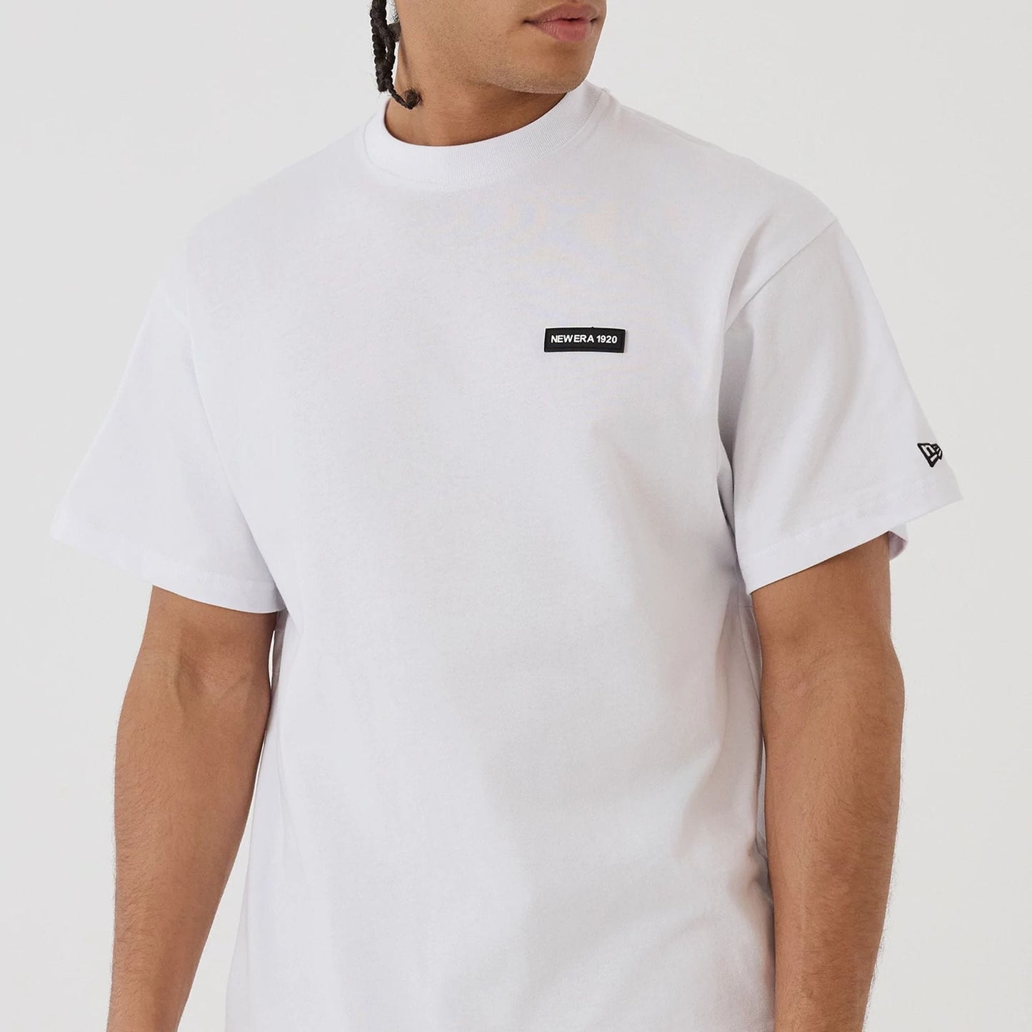 The model is wearing this New Era Distressed T-Shirt in white. 5