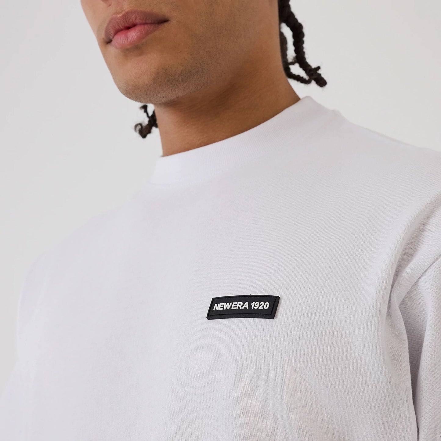 The model is wearing this New Era Distressed T-Shirt in white. 4