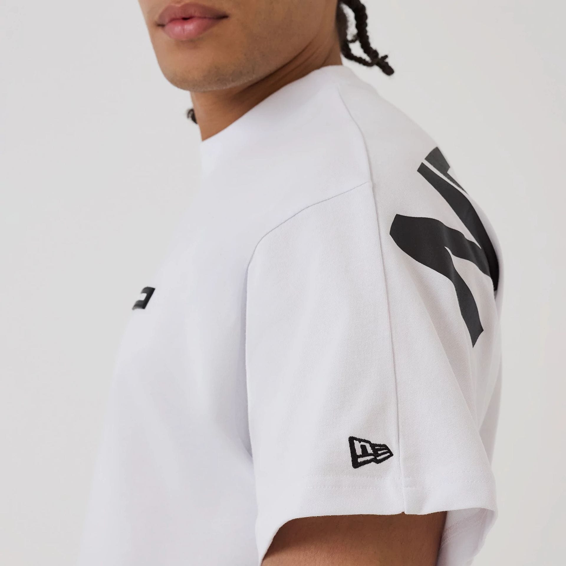 The model is wearing this New Era Distressed T-Shirt in white. 6