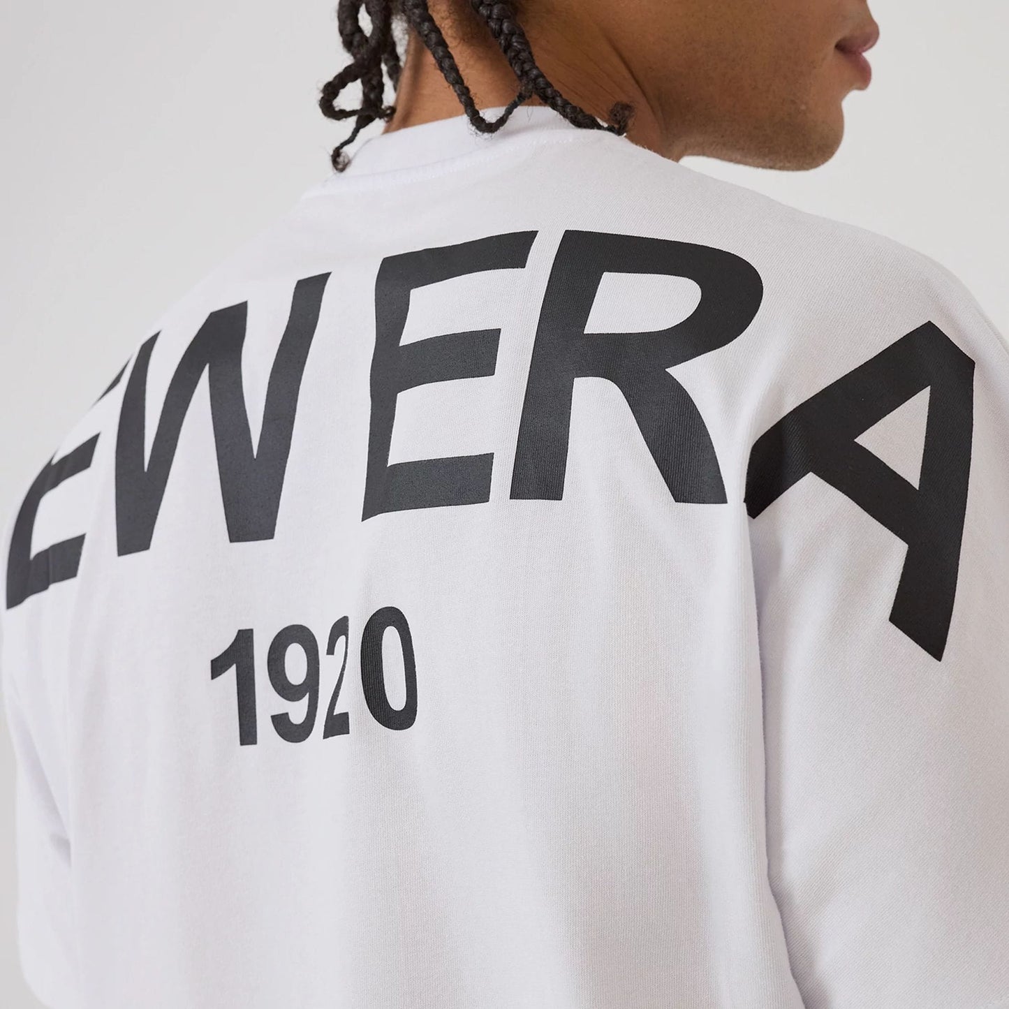 The model is wearing this New Era Distressed T-Shirt in white. 3