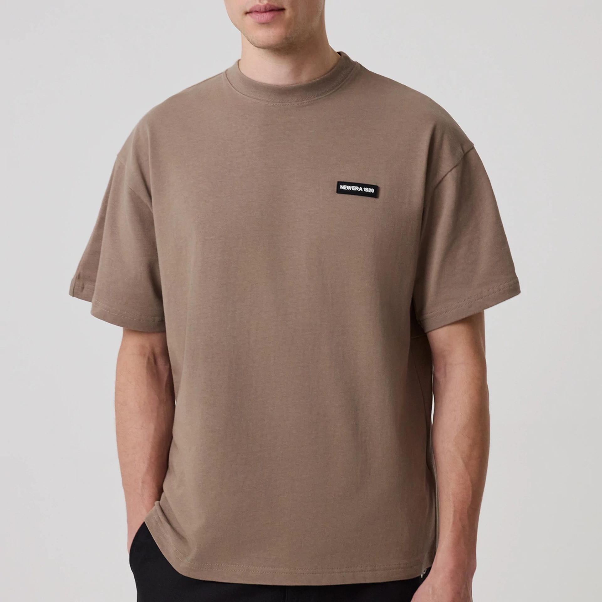 The model is wearing this New Era Distressed T-Shirt in Brown. 6