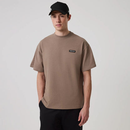The model is wearing this New Era Distressed T-Shirt in Brown. 1