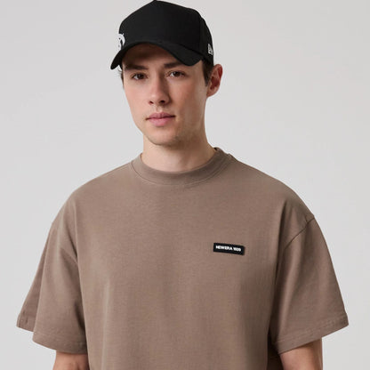 The model is wearing this New Era Distressed T-Shirt in Brown. 7