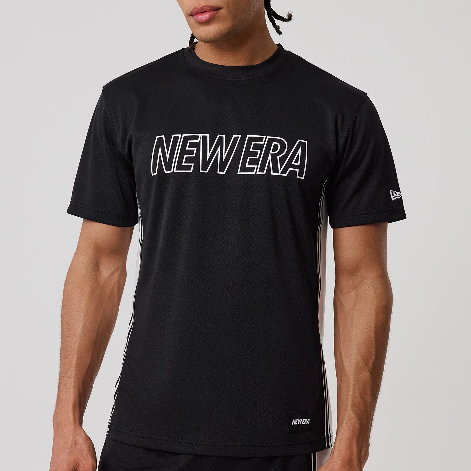 The model is wearing this New Era Mesh T-Shirt in black. 5