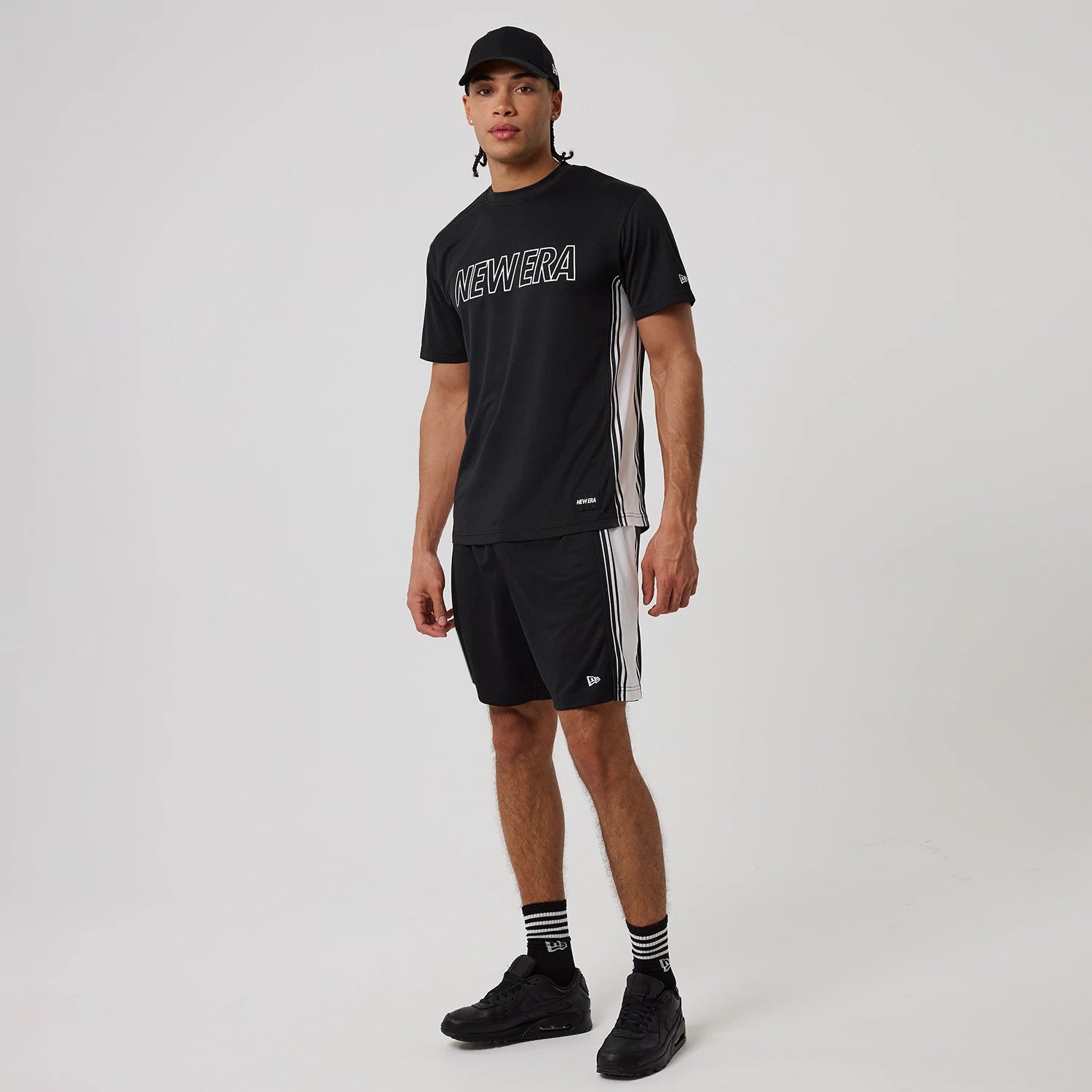 The model is wearing this New Era Mesh T-Shirt in black. 8