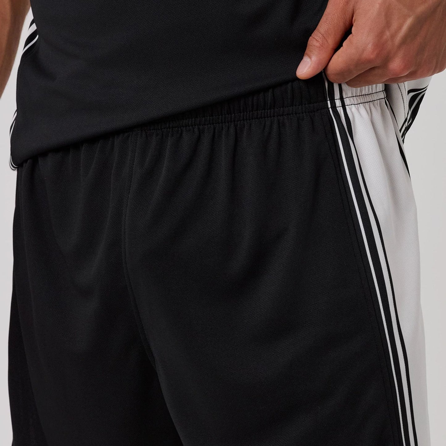 The model is wearing this New Era Mesh Oversized Shorts in black. 6