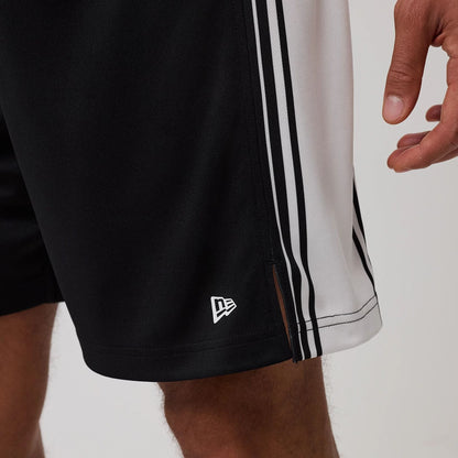 The model is wearing this New Era Mesh Oversized Shorts in black. 7