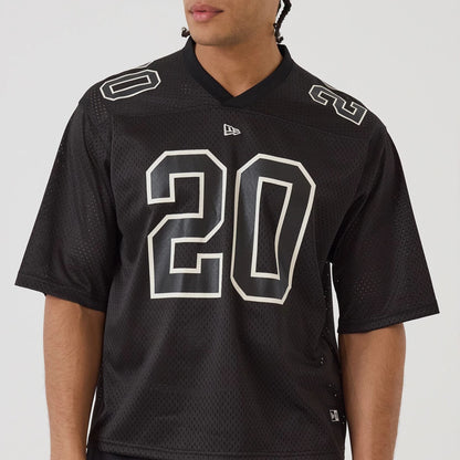 The model is wearing this New Era Mesh Football Short Sleeve Shirt in black. 5