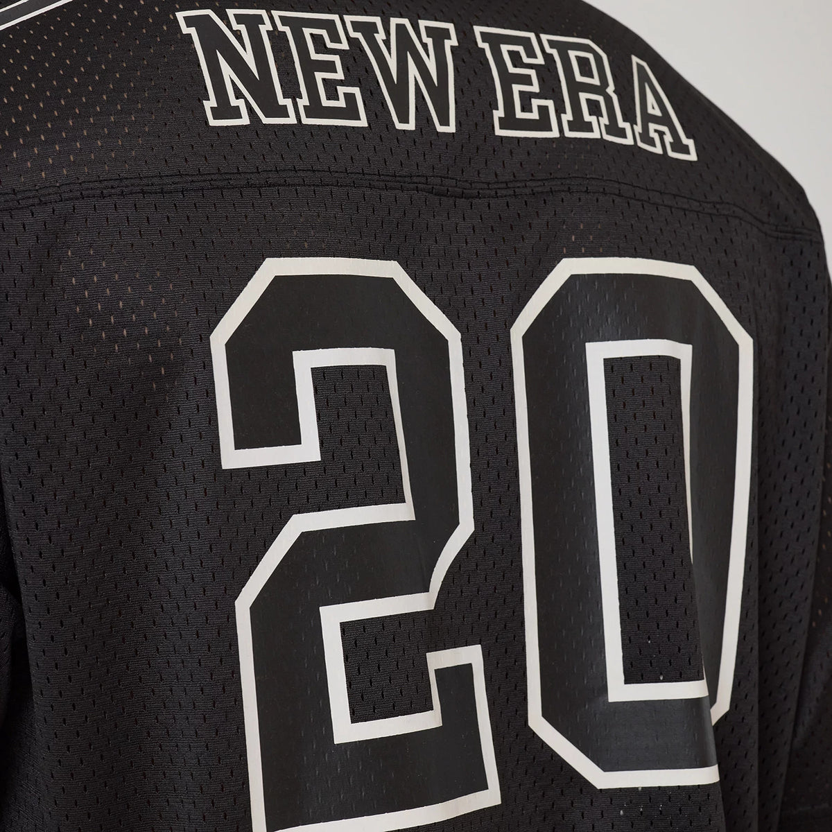 New Era Mesh Football Black Short Sleeve Shirt, back view showing white embroidered "NEW ERA" lettering across the shoulder and large white outlined number 20 printed at the centre of the black mesh fabric.