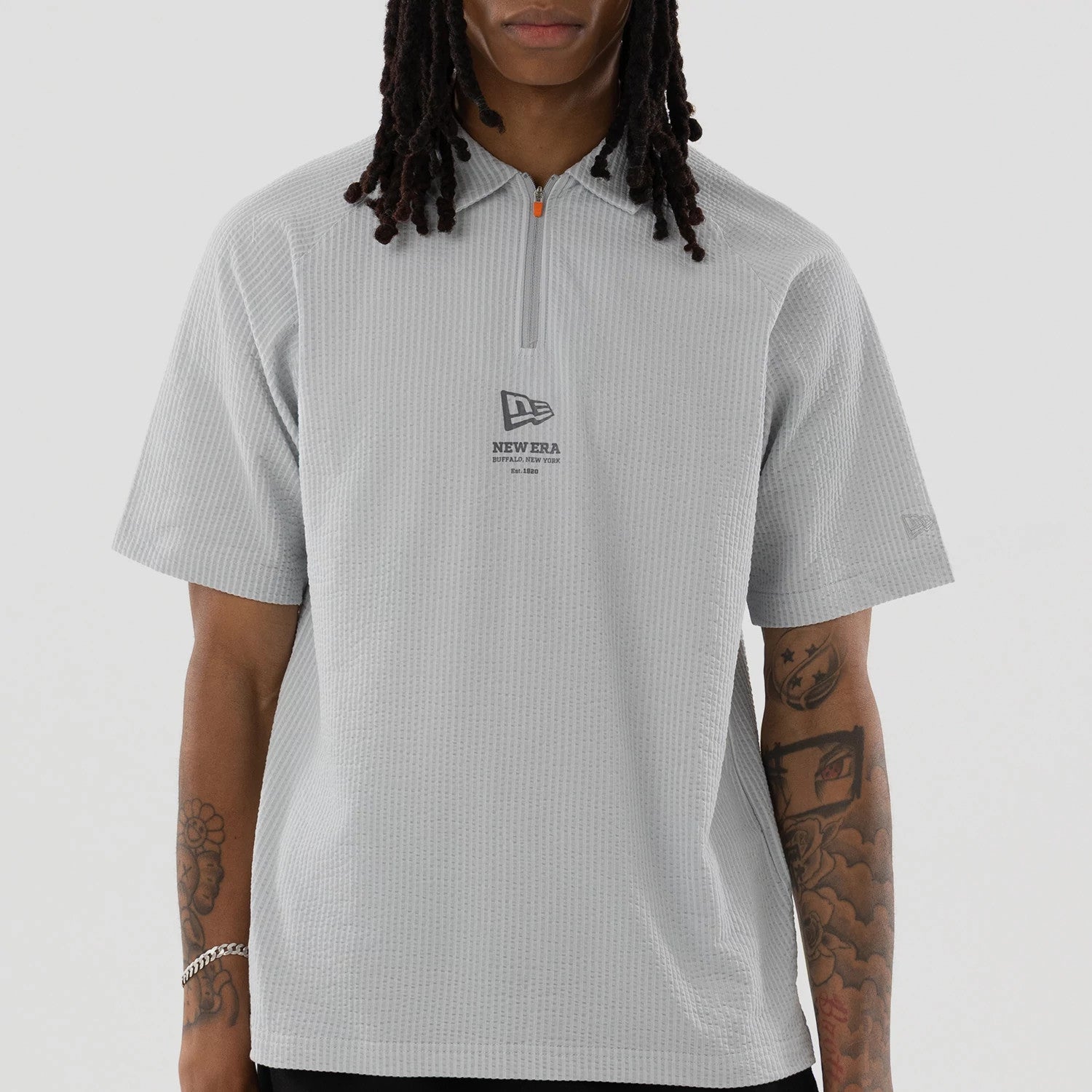 The model is wearing this New Era Seersucker Polo T-Shirt in grey. 3