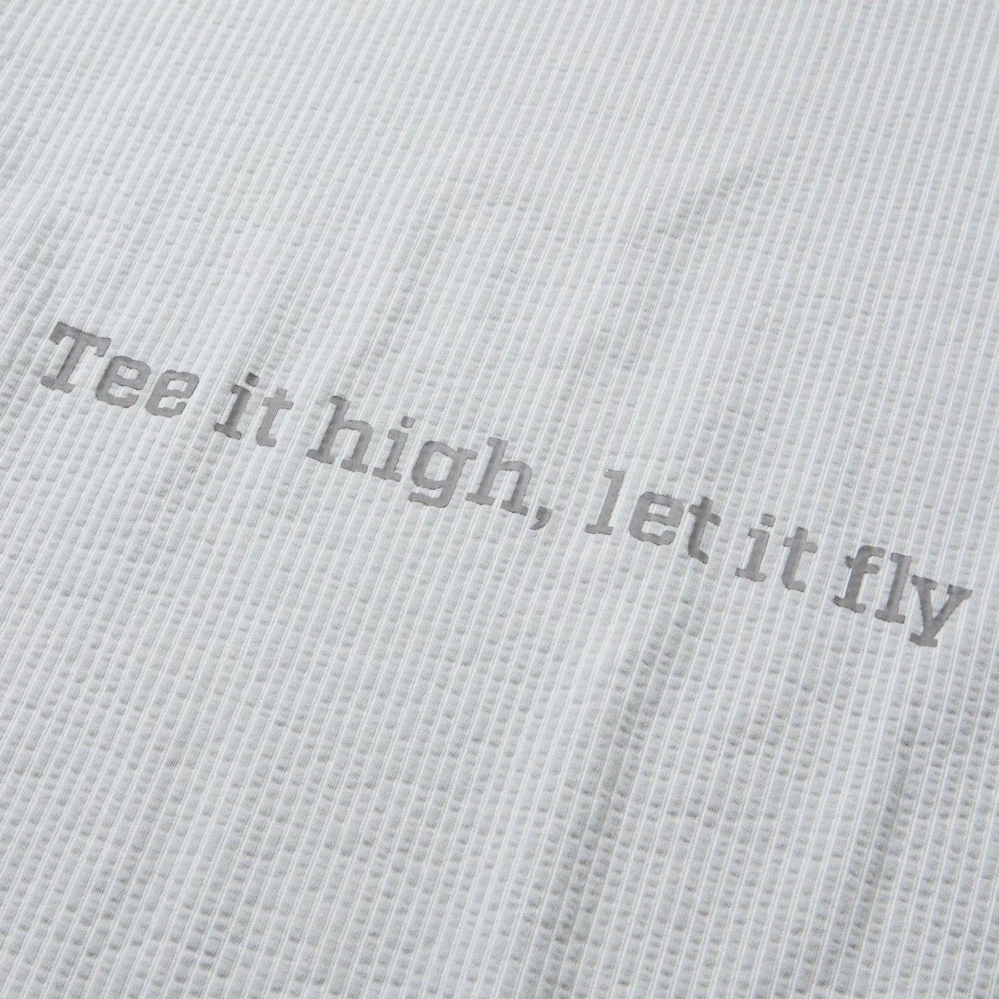 The model is wearing this New Era Seersucker Polo T-Shirt in grey. 8