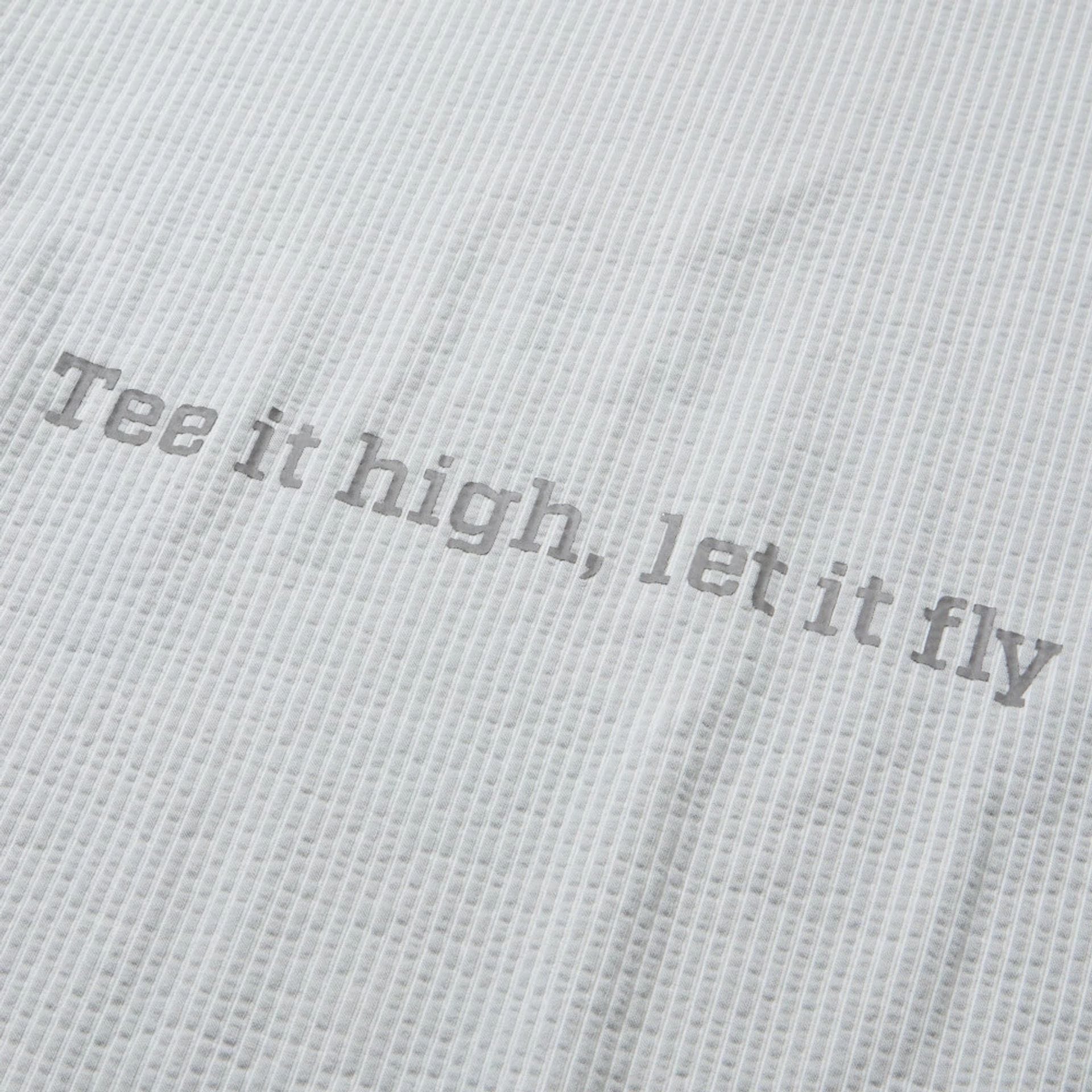 The model is wearing this New Era Seersucker Polo T-Shirt in grey. 8