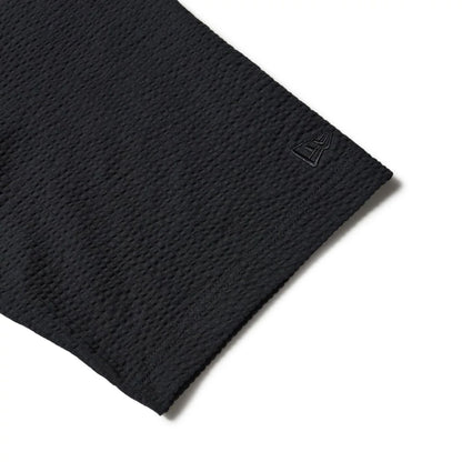 The model is wearing this New Era Seersucker Polo T-Shirt in black. 6