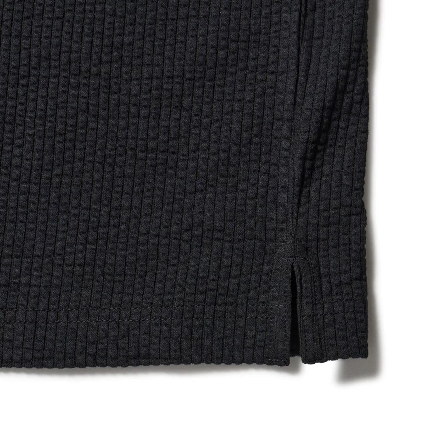 The model is wearing this New Era Seersucker Polo T-Shirt in black. 5