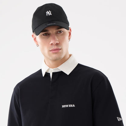 The model is wearing this New Era Short Sleeve Rugby Shirt in black. 6