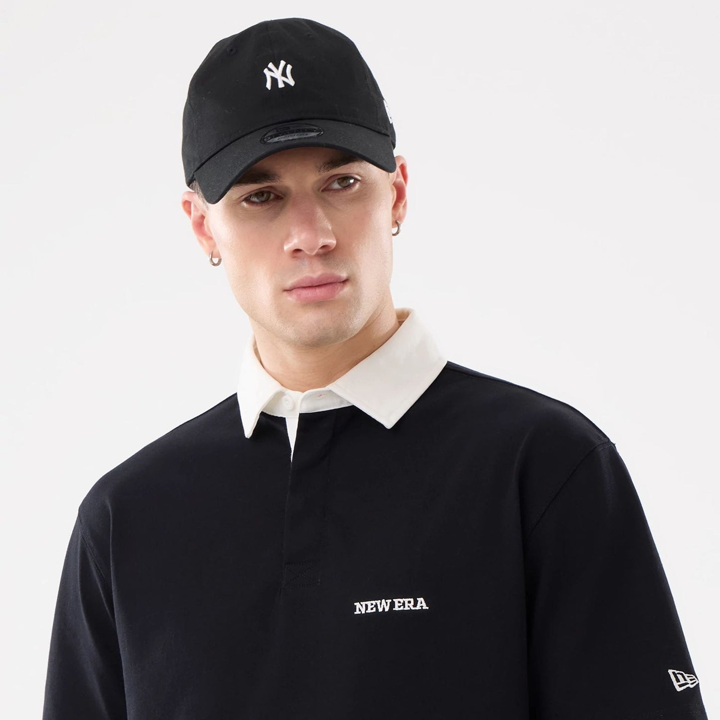 The model is wearing this New Era Short Sleeve Rugby Shirt in black. 6