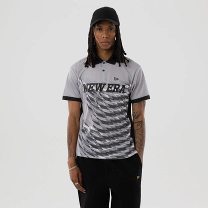 The model is wearing this New Era Grid Polo T-Shirt in grey. 1