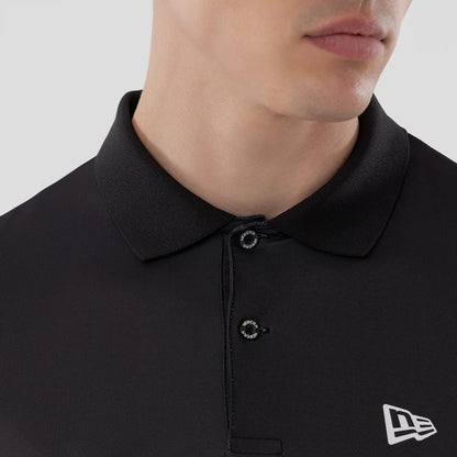 The model is wearing this New Era Grid Polo T-Shirt in black. 5