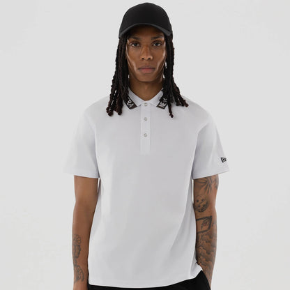 The model is wearing this New Era Kanoko Polo T-Shirt in white. 4