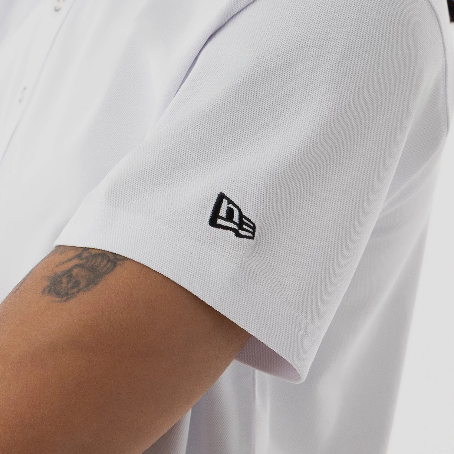 The model is wearing this New Era Kanoko Polo T-Shirt in white. 5