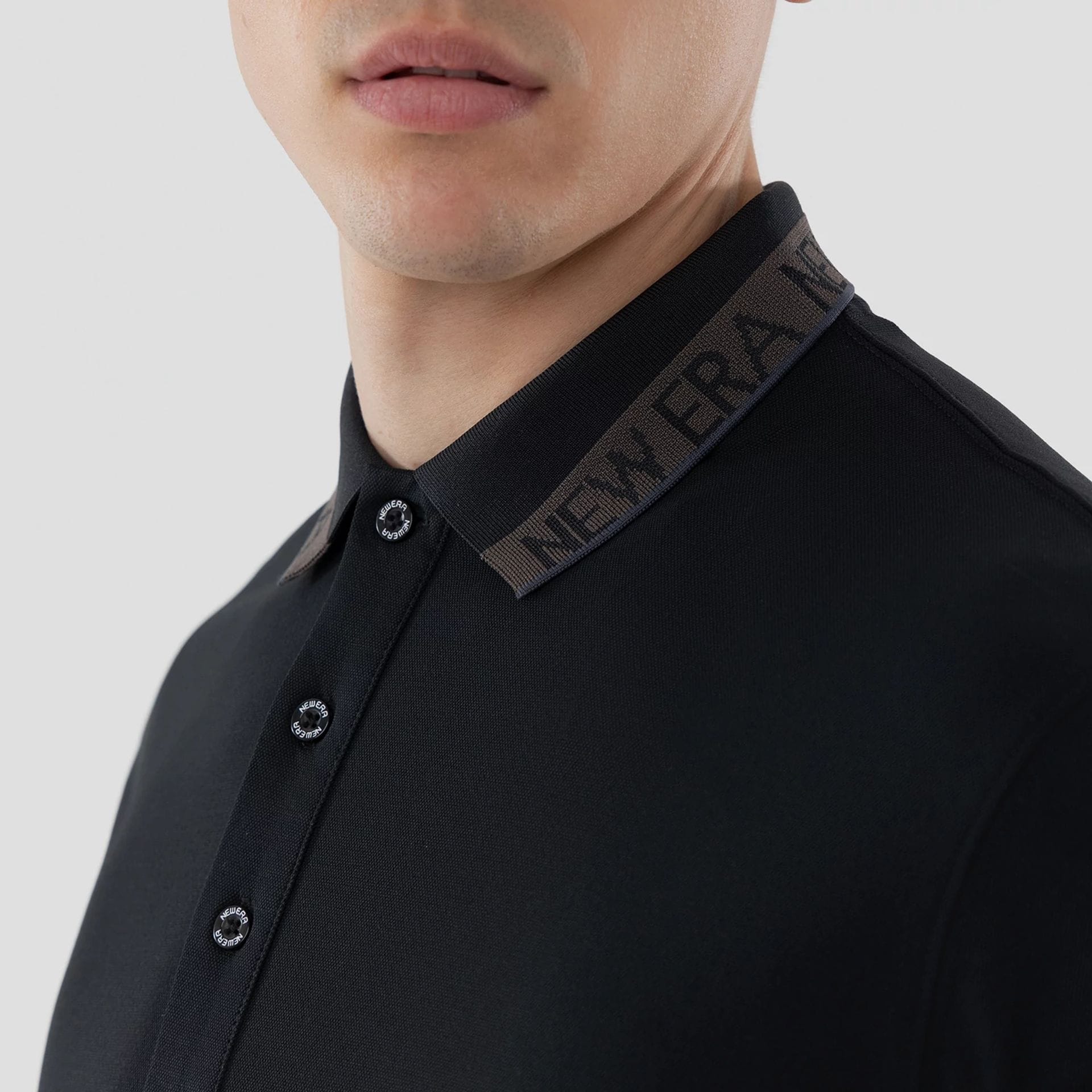 The model is wearing this New Era Kanoko Polo T-Shirt in black. 5