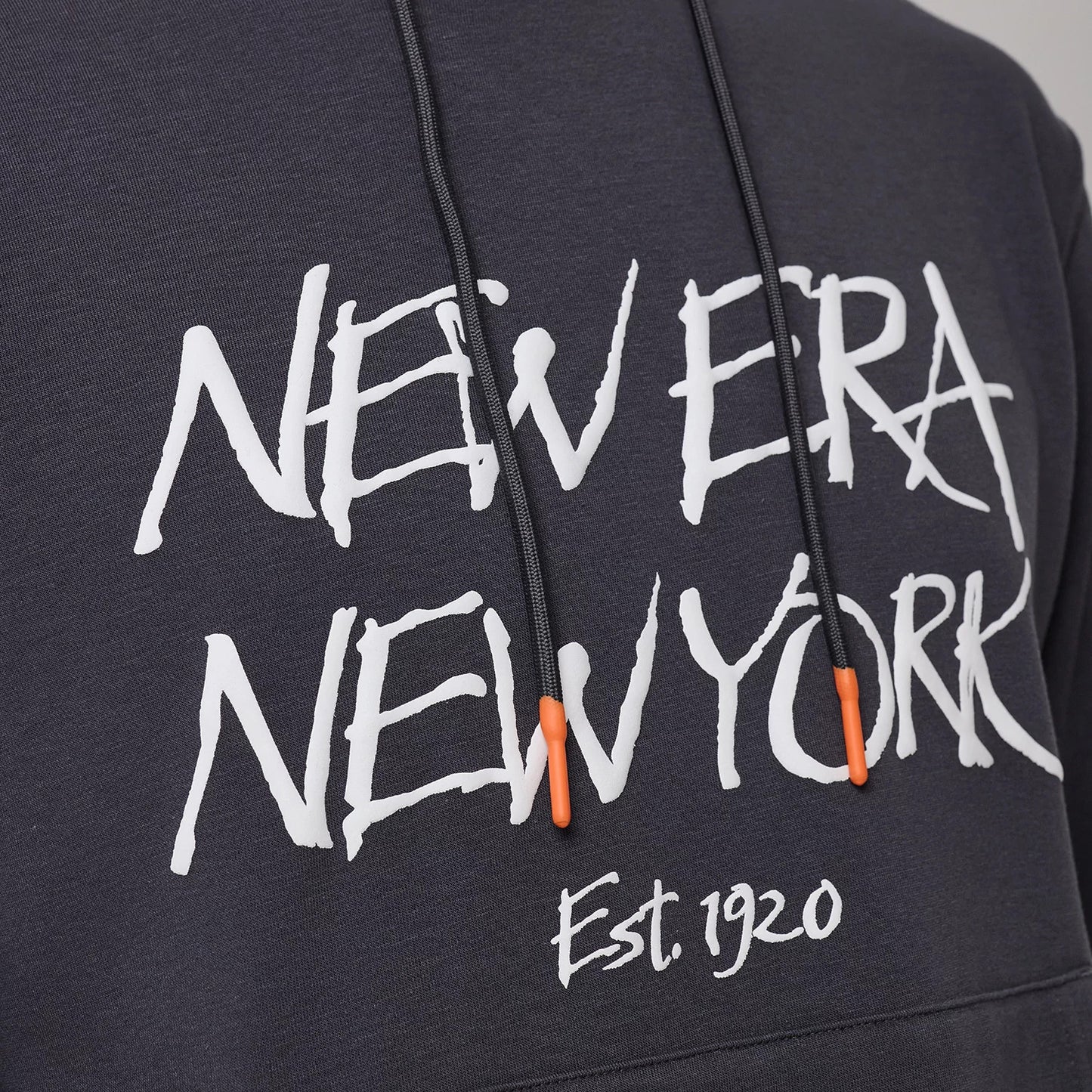 The model is wearing this New Era New York Oversized Pullover Hoodie in dark grey. 3