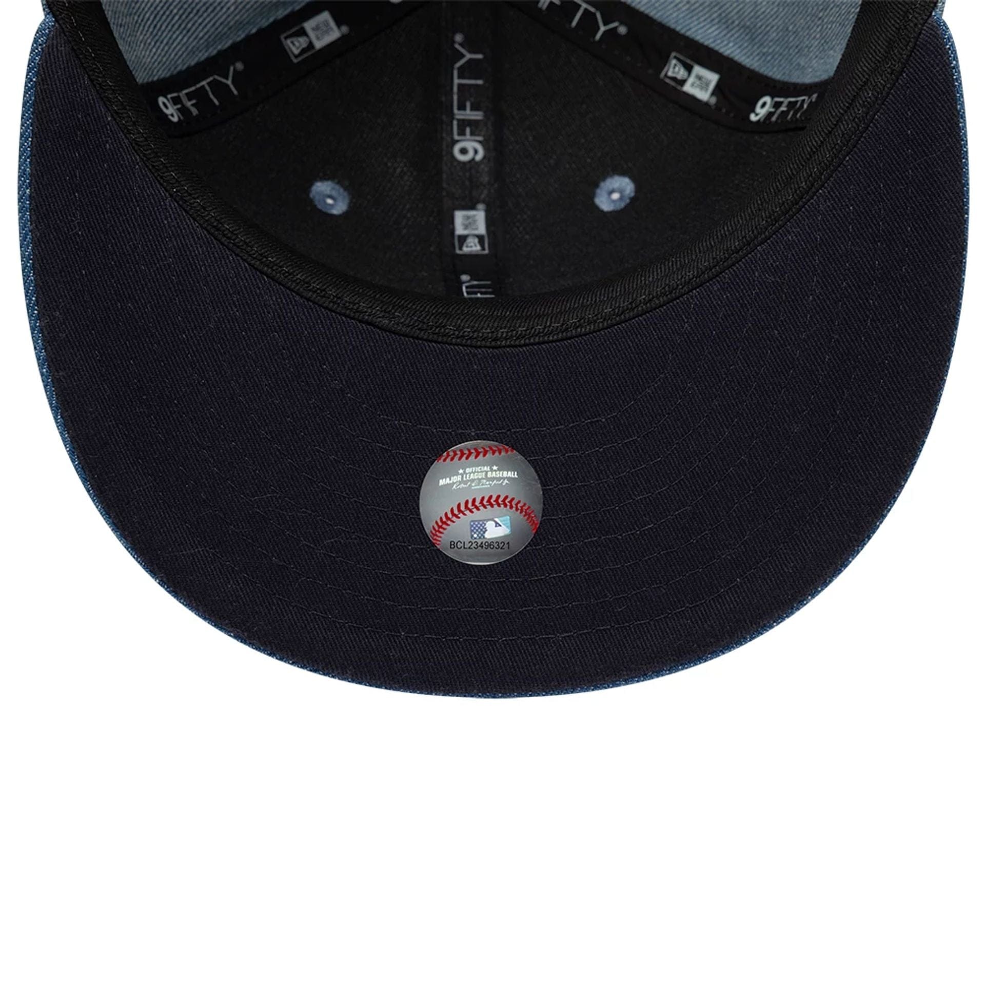 Pictured is this MLB Washed Denim New York Yankees 9FIFTY Snapback cap in navy. 2