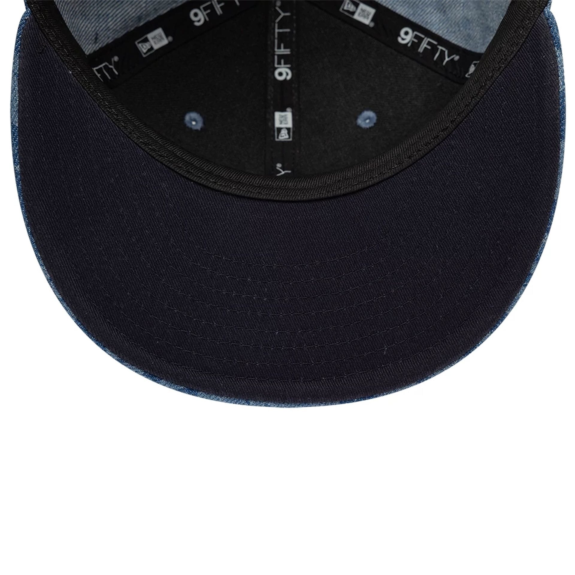 Pictured is this New Era Laser Burnout Washed Denim 9FIFTY Snapback Adjustable cap in navy. 2