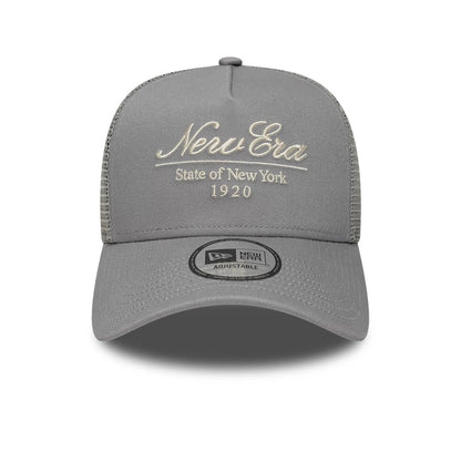 Pictured is this New Era Script 9FORTY A-Frame Trucker cap in grey. 2