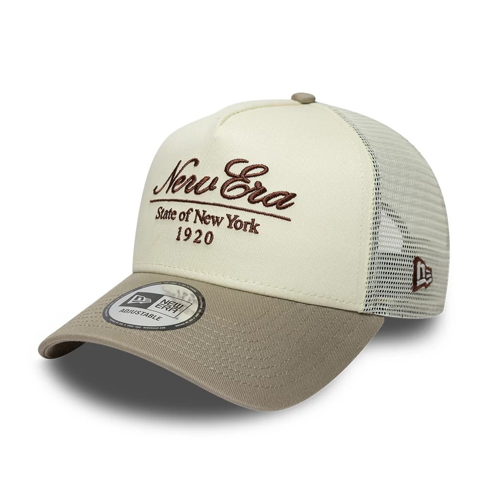 Pictured is this New Era Script 9FORTY A-Frame Trucker cap in cream. 1