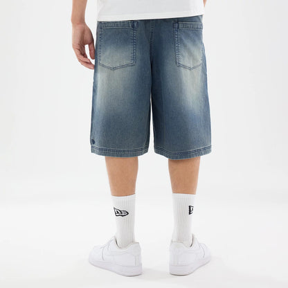 The model is wearing this New Era Washed Bermuda Shorts in blue. 2