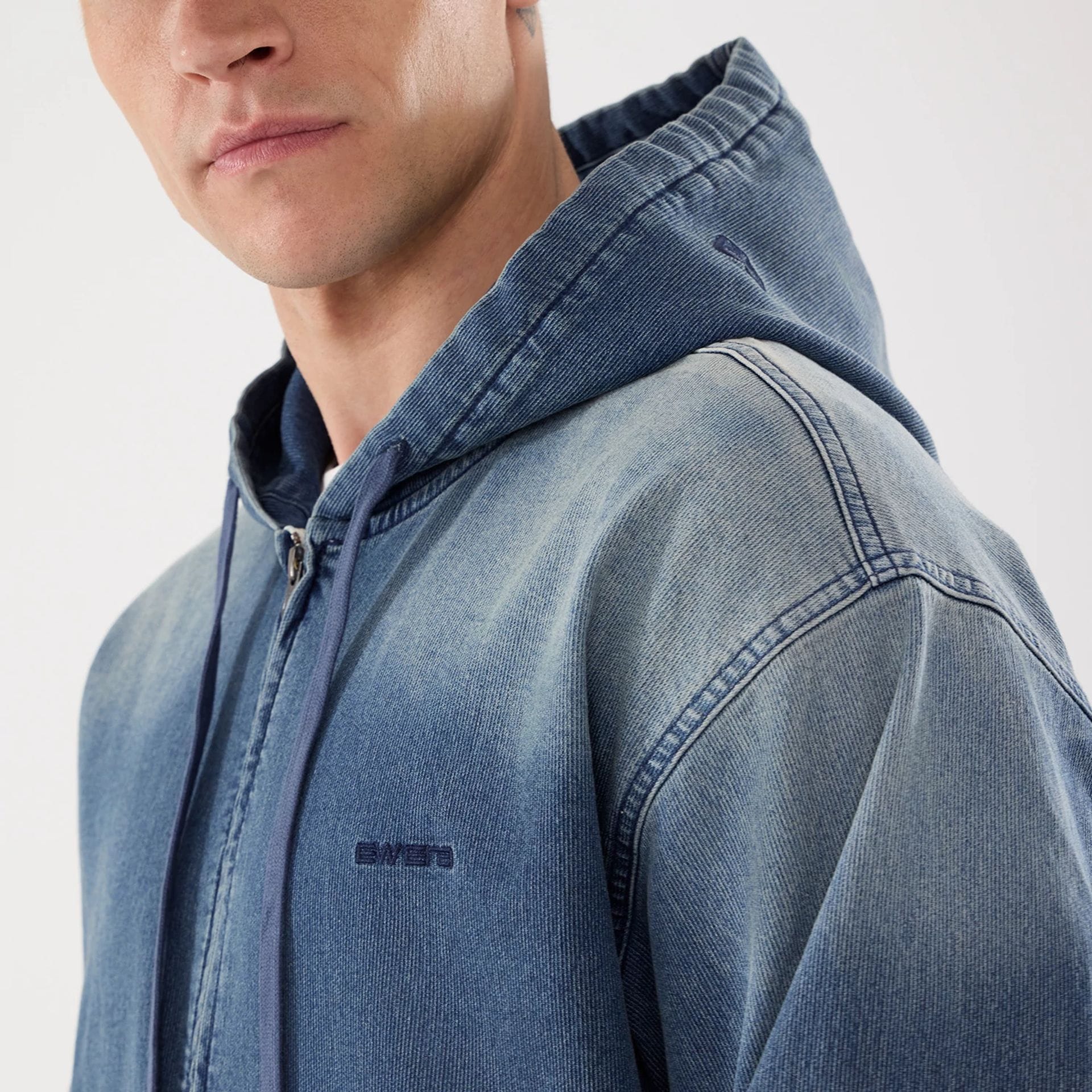 The model is wearing this New Era Washed Full Zip Hoodie in blue. 4