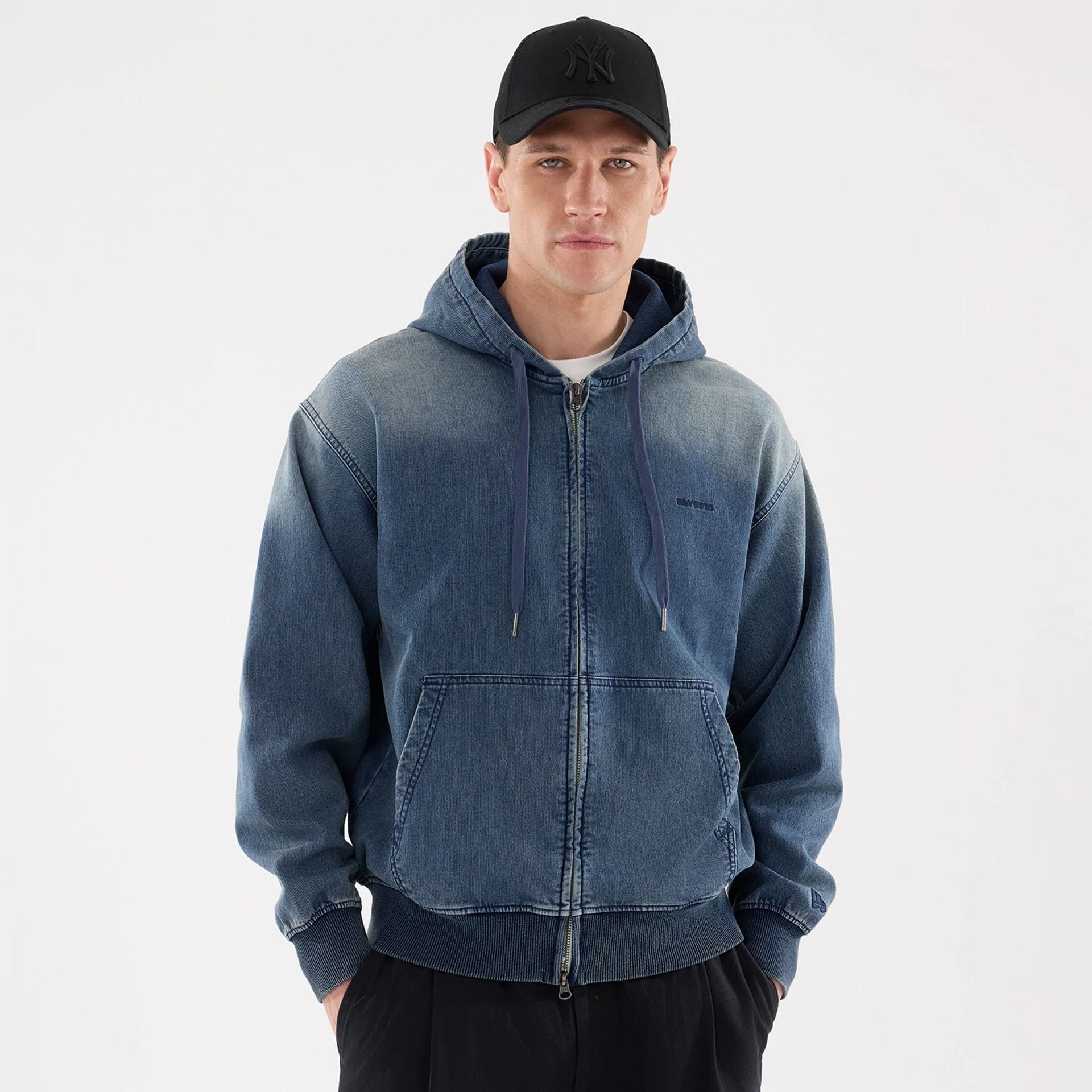 The model is wearing this New Era Washed Full Zip Hoodie in blue. 1