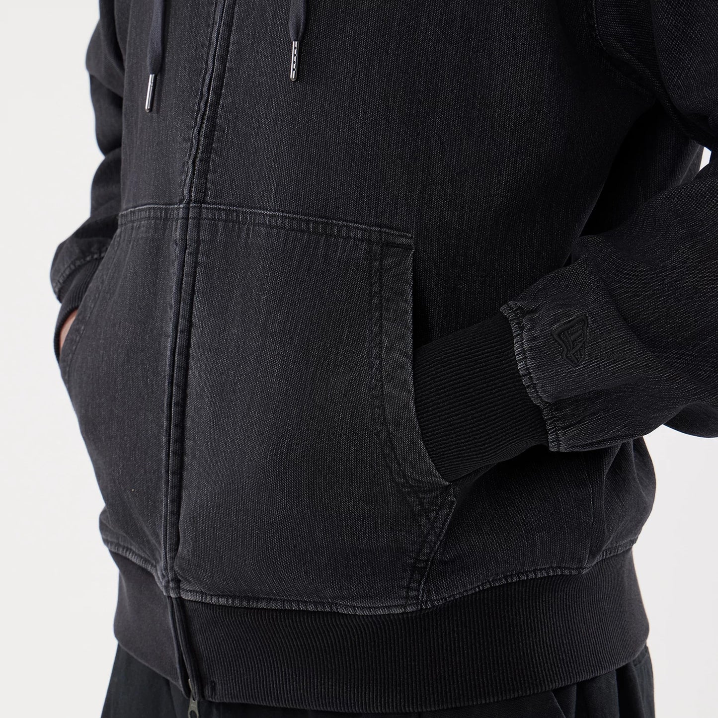 The model is wearing this New Era Washed Full Zip Hoodie in black. 5