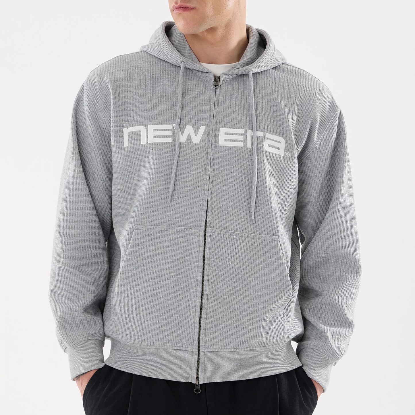 The model is wearing this New Era Waffle Full Zip Hoodie in grey. 3