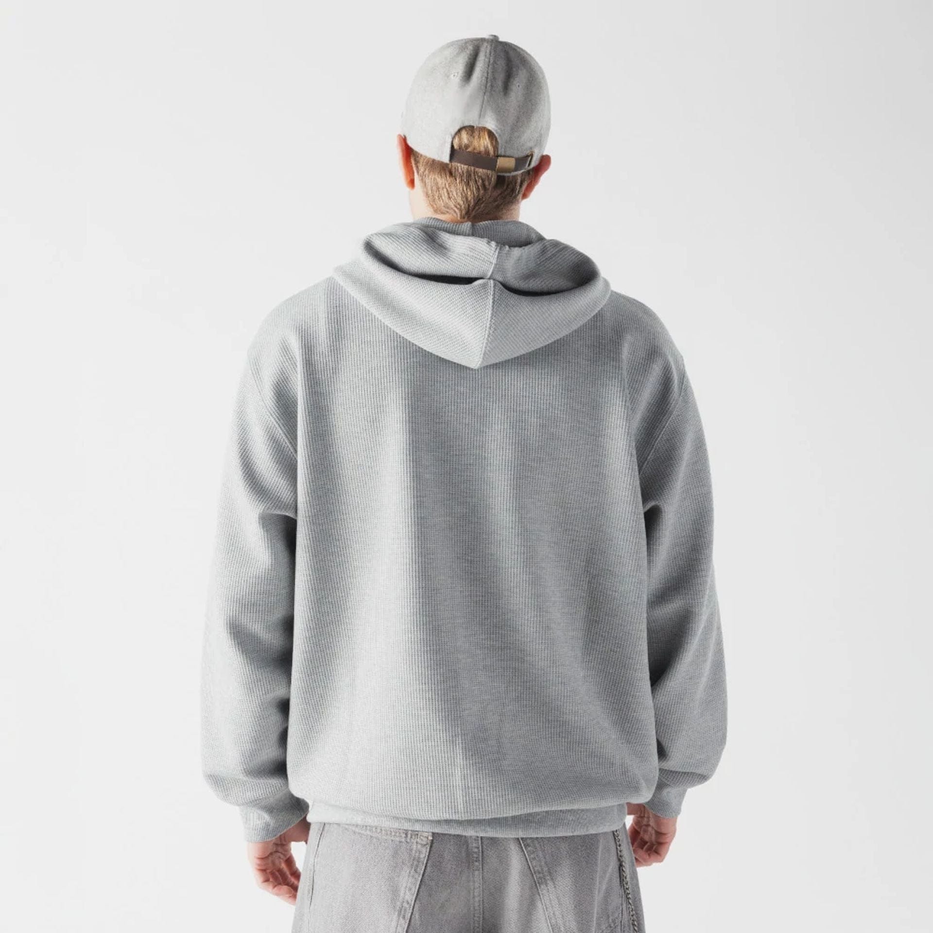 The model is wearing this New Era Waffle Full Zip Hoodie in grey. 2