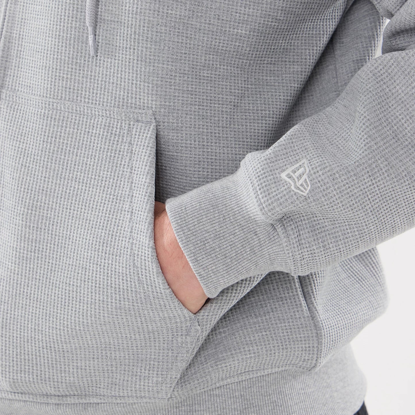 The model is wearing this New Era Waffle Full Zip Hoodie in grey. 5