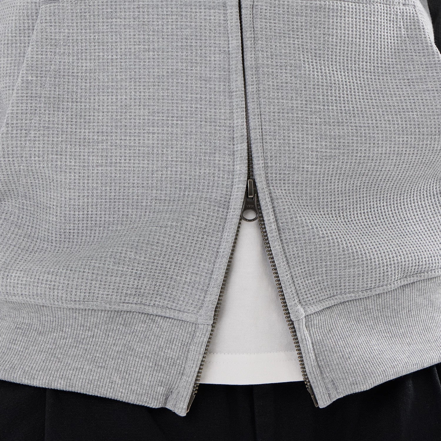 The model is wearing this New Era Waffle Full Zip Hoodie in grey. 6