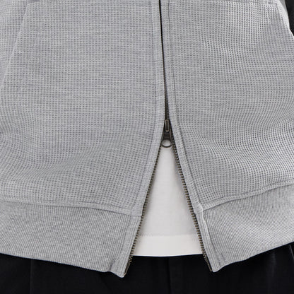 The model is wearing this New Era Waffle Full Zip Hoodie in grey. 6