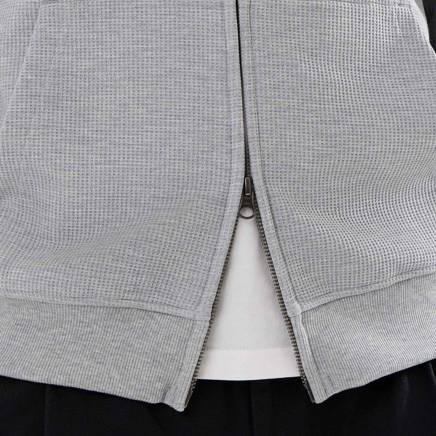 The model is wearing this New Era Waffle Full Zip Hoodie in grey. 6