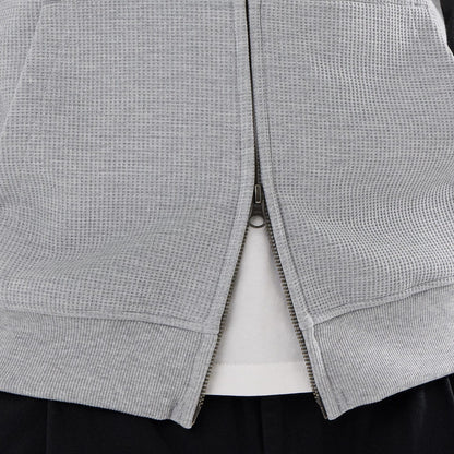 The model is wearing this New Era Waffle Full Zip Hoodie in grey. 6