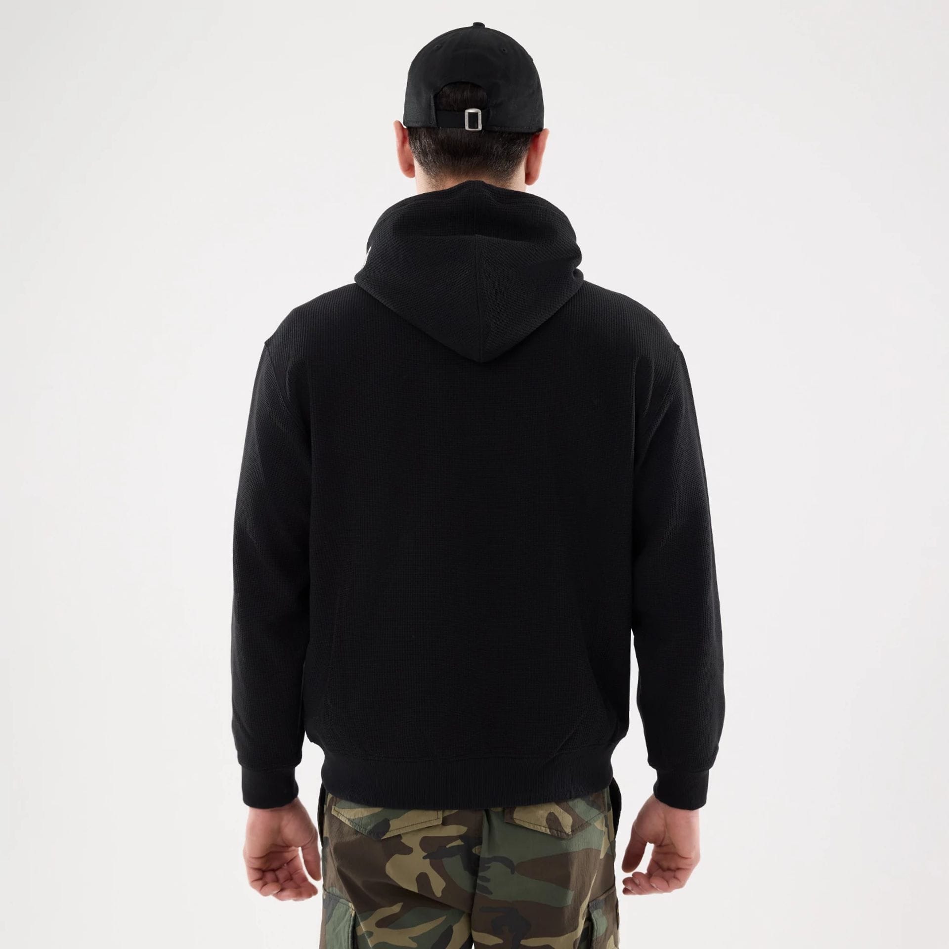 The model is wearing this New Era Waffle Full Zip Hoodie in black. 2