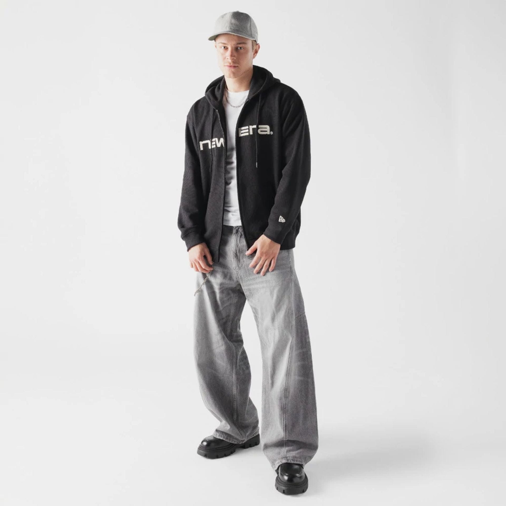 The model is wearing this New Era Waffle Full Zip Hoodie in black. 6