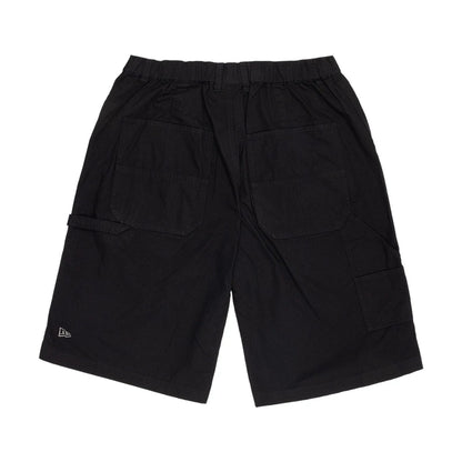 The model is wearing this New Era Canvas Bermuda Shorts in black. 2