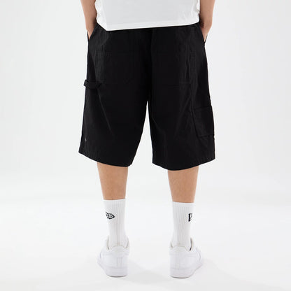 The model is wearing this New Era Canvas Bermuda Shorts in black. 2