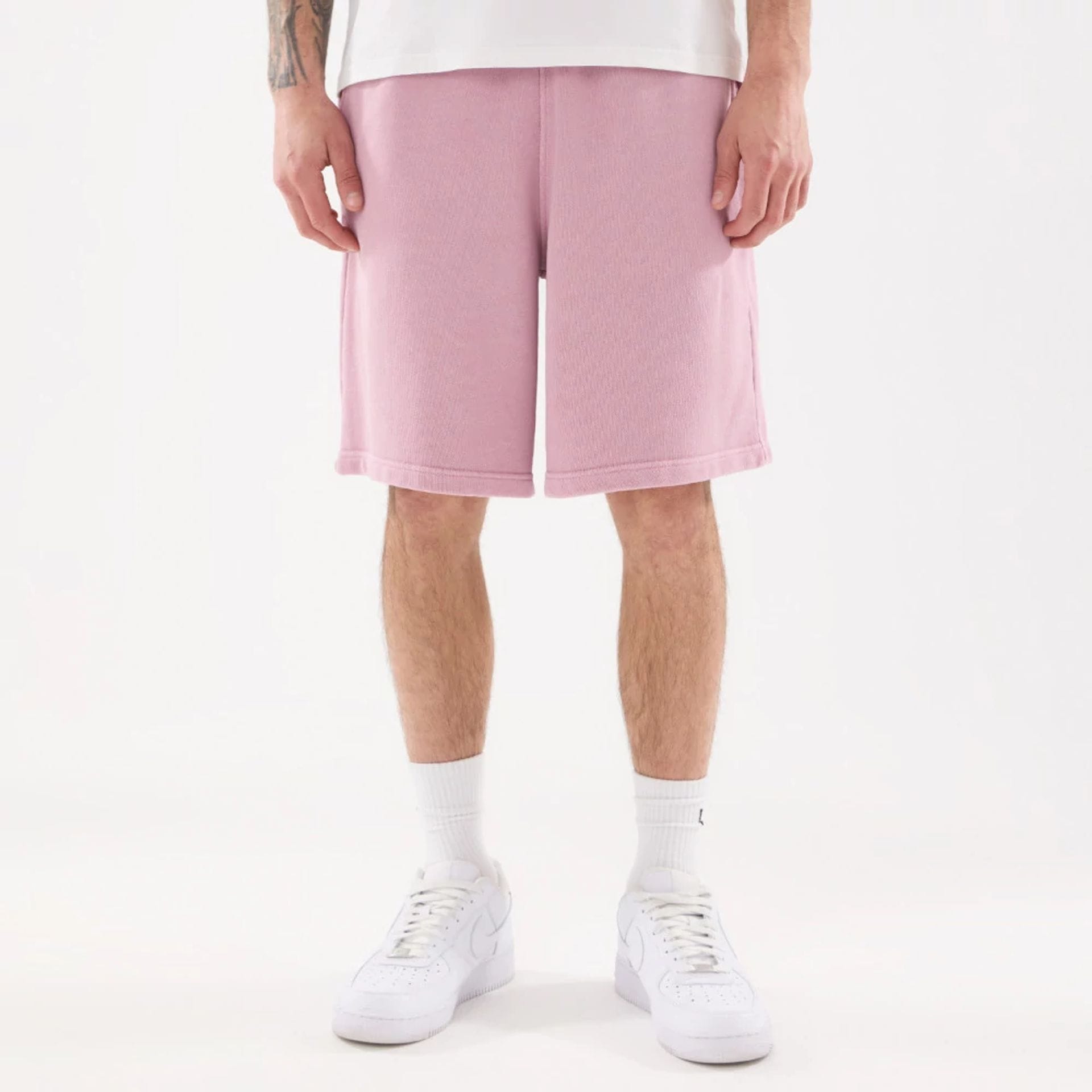 The model is wearing this New Era Originators Oversized Shorts in pink. 1