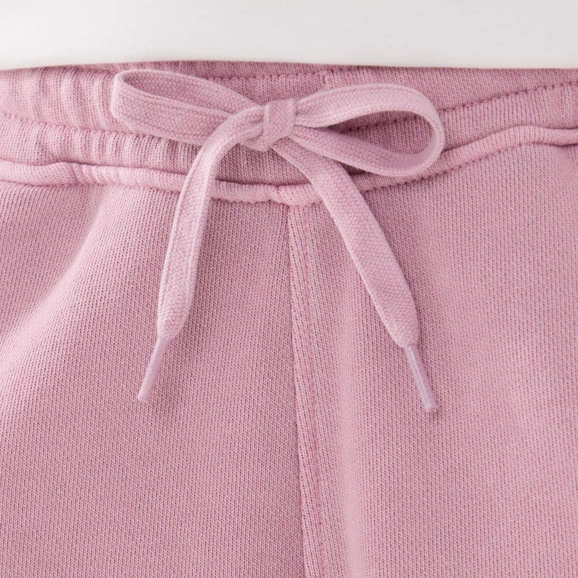 The model is wearing this New Era Originators Oversized Shorts in pink. 3