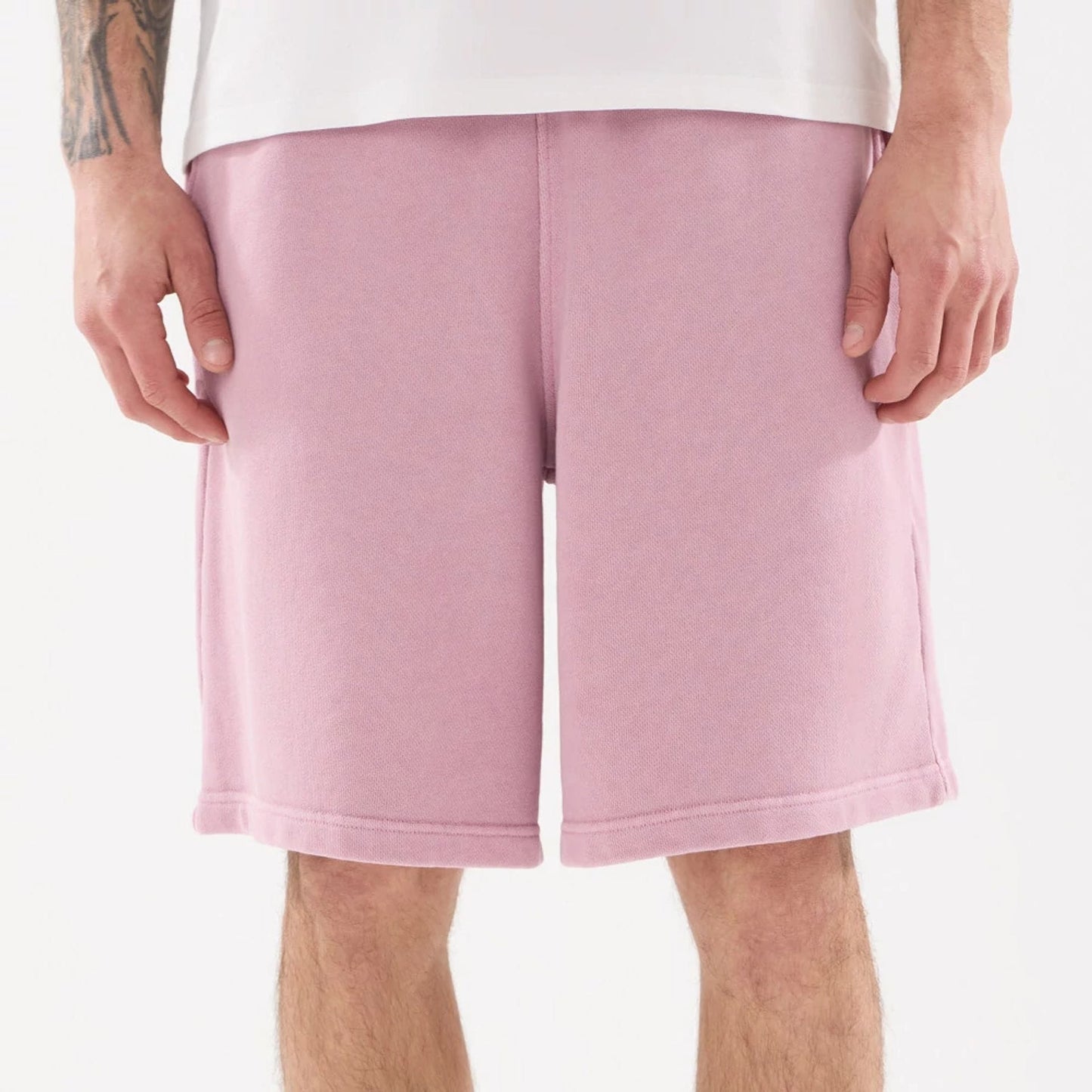 The model is wearing this New Era Originators Oversized Shorts in pink. 8