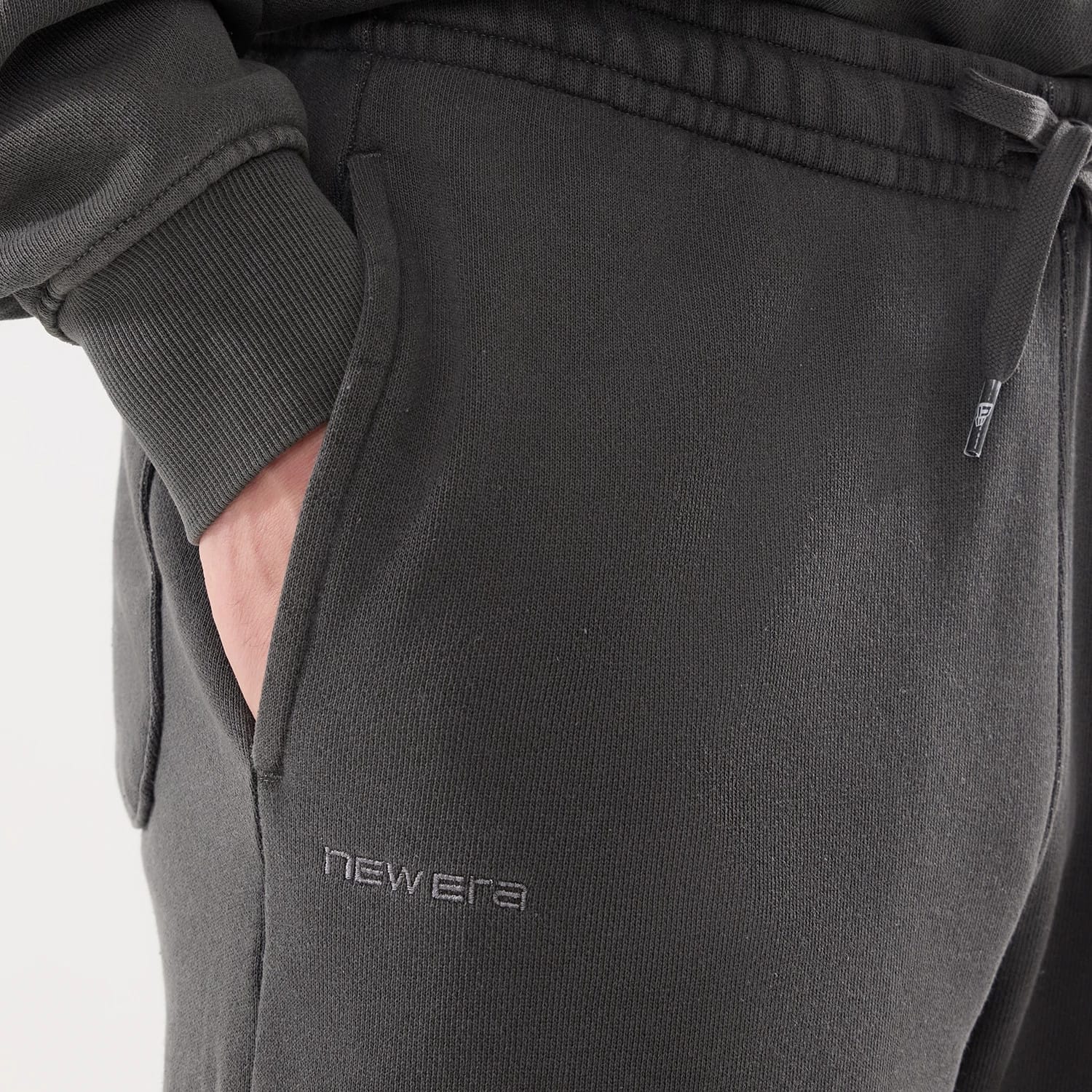 The model is wearing this New Era Originators Straight Leg Joggers in black. 3