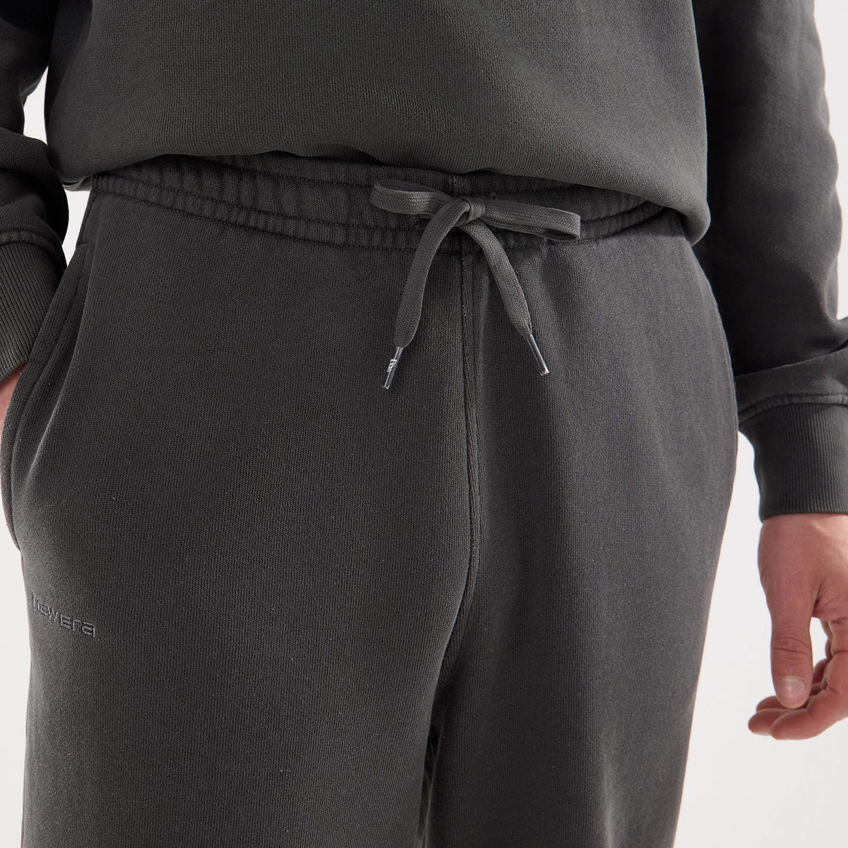 The model is wearing this New Era Originators Straight Leg Joggers in black. 5